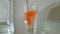 A spoonful of paprika powder is added to the glass with water and mixed