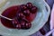 Spoonful of sour Morello cherries on vintage ceramic platter