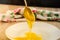 A spoonful of sweet, fresh honey. Honey in a spoon on a white plate background. Close-up.