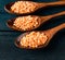 Spoons filled with uncooked lentil for soup