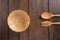 Spoons, forks, wooden bowl on wooden background