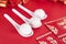 Spoons and red envelopes with dumplings on the red background