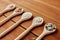 Spoons with salt and spices on wooden table