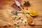 Spoons, spice and selection of seasoning for health on kitchen table, turmeric and cardamom for meal. Top view