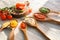 Spoons with tasty sauces on white wooden table