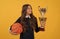sport achievement award. teen girl with basketball ball and champion cup.