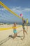 Sport activity and health. Couple in love play volleyball on sunny beach. Sexy woman and muscular man with ball at net