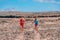 Sport athletes runners trail running training endurance in desert summer landscape. Man runner wearing compression