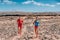 Sport athletes runners trail running training endurance in desert summer landscape. Man runner wearing compression