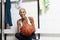 Sport basketball player in the locker room, a smiling African American female athlete holding the ball before the game,