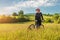 Sport bike woman relaxing on a meadow, beautiful landscape