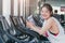 Sport braces glasses teen girl with smartphone standing smile on treadmill in sportclub