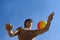 Sport build teenager with ball and blue sky