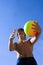 Sport build teenager with variegated ball and sky