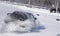 A sport car which is drifting in the cloud of snow