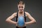 Sport caucasian girl with slim figure do exercises with blue ball isolated on black background