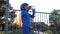 Sport child drinks mineral water from bottle outdoors in backlight