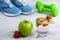 Sport composition with sports equipment glass water apple strawberry