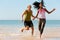 Sport couple jogging on the beach