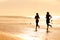 Sport couple jogging on the beach