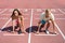 Sport couple start competition running at arena track
