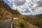 Sport cyclist on a narrow winding asphalt road between hills on the beautiful mediterranean island Mallorca