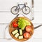 Sport and diet concept - bicycle model, fresh vegetables and ce
