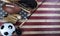 Sport equipment for baseball, football, soccer and fishing on vintage wooden USA flag