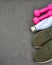 Sport equipment. Sport shoes, pink dumbbells on black background