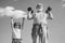 Sport exercise for kids. Lifting dumbbells. Portrait of senior man and cute child lifting dumbbells. Grandfather and son