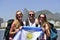 Sport fans friends in Rio de Janeiro holding Argentinian flag.