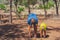 Sport father son exercising in forest park fresh air, workout enjoying together, squatting and side bend technique, walk