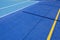 Sport field court background. Blue rubberized and granulated ground surface with white, yellow lines and tennis net