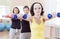 Sport and Fitness Ideas. Group of Three Caucasian Female Athletes Having a Workout Training with Barbells Indoors