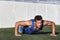 Sport fitness man push-ups. Male athlete exercising push up outside in sunny sunshine. Fit shirtless male fitness model in