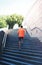 Sport, fitness - sportsman is running in the city, male runner on steps stairs