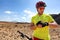 Sport fitness watch mountain biker on mtb bike using smartwatch app for fitness challenge. Young man athlete using his wearable