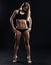 Sport fitness woman with strong muscles on black background