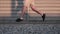 Sport footage, detail legs of men running on empty street beside cornfields. Slow motion. Dolly shot