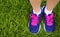 Sport Footwear on Female Feet on Green Grass. Closeup