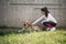 Sport girl caring her dog while resting in nature