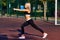 Sport girl. The girl is doing fitness exercises. Beautiful young sports woman doing exercises. A girl is training on a sports fiel