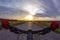 Sport hands on the steering wheel riding a cyclist on the road towards sunset