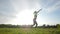 Sport and healthy lifestyle concept. Young athletic woman in a long jump sunny sky background