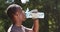 Sport and hydration concept. Young african american man athlete drinking water, resting during workout outdoors
