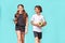 Sport is life. Two teenagers, boy and girl with yoga mat and bottle of water looking at camera and smiling while