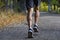 Sport man with ripped athletic and muscular legs running off road in jogging training workout at countryside in Autumn background