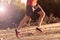 Sport man with ripped athletic and muscular legs running uphill off road in jogging training workout