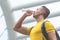 sport man in yellow is drink water in city outdoor
