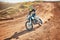 Sport, motorcycle and person driving in a desert for fitness, training and extreme sports in nature. Biking, motorbike